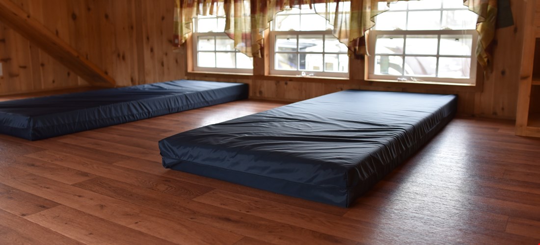 small mattresses for children in loft of deluxe cabin